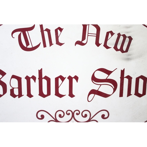 121 - ' The New Barber Shop ' hanging sign, of oval form, with burgundy lettering on a white ground, measu... 