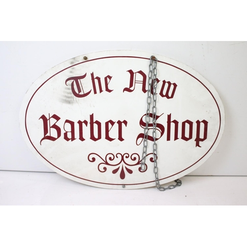 121 - ' The New Barber Shop ' hanging sign, of oval form, with burgundy lettering on a white ground, measu... 