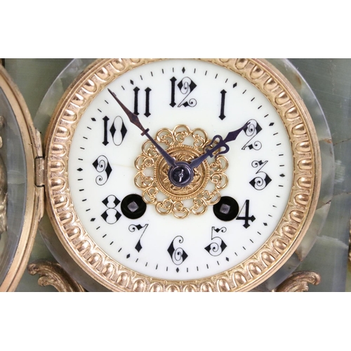 147 - Late 19th century onyx & gilt metal clock garniture, the clock with cream dial and surmounted by a t... 