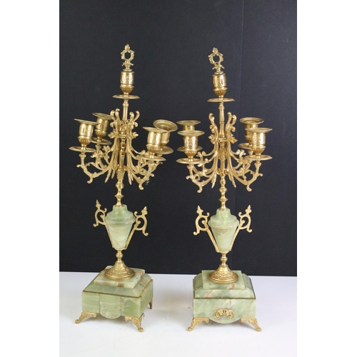 147 - Late 19th century onyx & gilt metal clock garniture, the clock with cream dial and surmounted by a t... 
