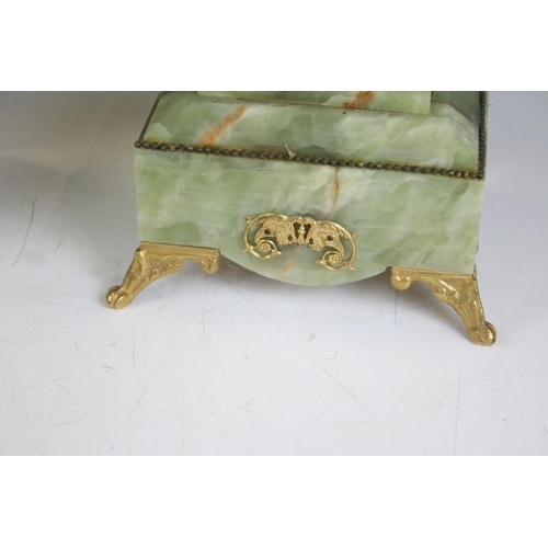 147 - Late 19th century onyx & gilt metal clock garniture, the clock with cream dial and surmounted by a t... 