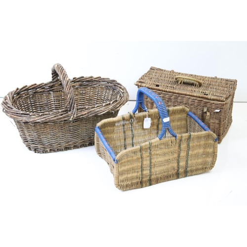 166 - Three wicker baskets to include a lidded picnic / fishing basket and an oval example with loop handl... 