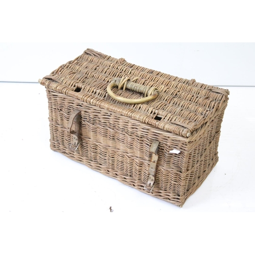 166 - Three wicker baskets to include a lidded picnic / fishing basket and an oval example with loop handl... 
