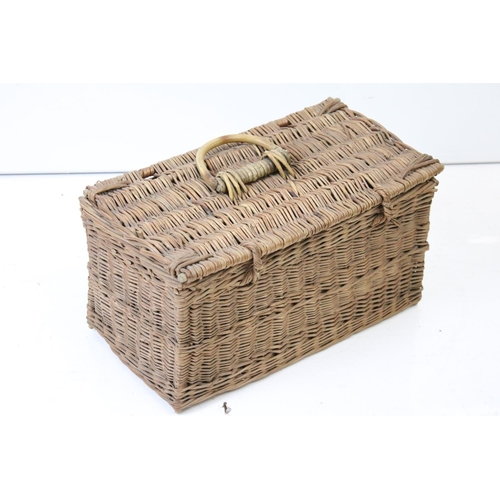 166 - Three wicker baskets to include a lidded picnic / fishing basket and an oval example with loop handl... 