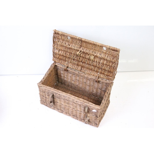166 - Three wicker baskets to include a lidded picnic / fishing basket and an oval example with loop handl... 