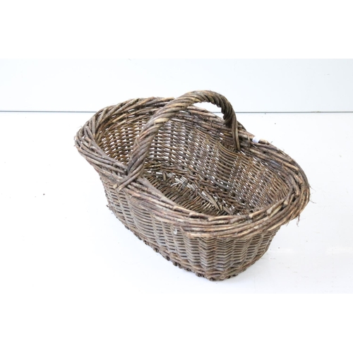 166 - Three wicker baskets to include a lidded picnic / fishing basket and an oval example with loop handl... 