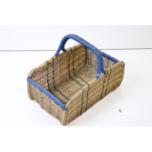 166 - Three wicker baskets to include a lidded picnic / fishing basket and an oval example with loop handl... 