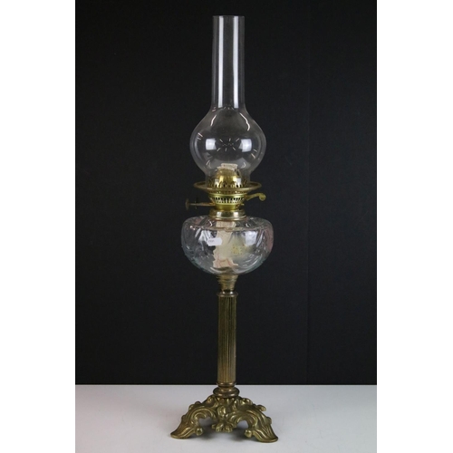 175 - 19th Century Victorian brass and glass oil lamp having a clear glass reservoir raised on a brass col... 