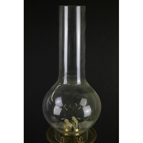 175 - 19th Century Victorian brass and glass oil lamp having a clear glass reservoir raised on a brass col... 