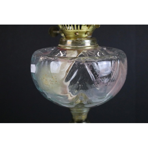 175 - 19th Century Victorian brass and glass oil lamp having a clear glass reservoir raised on a brass col... 