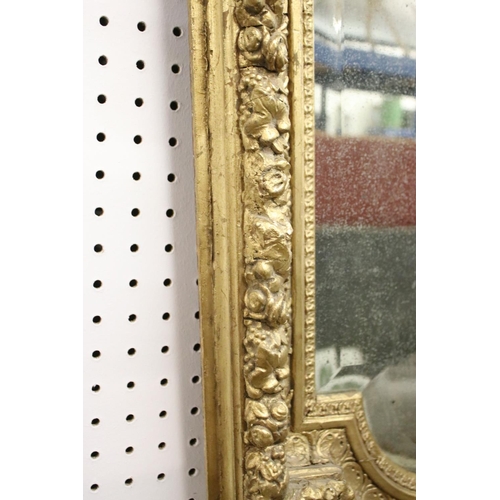 462 - 19th century Italian style shaped Wall Mirror held with a Floral Carved Giltwood and Gesso Frame, 10... 