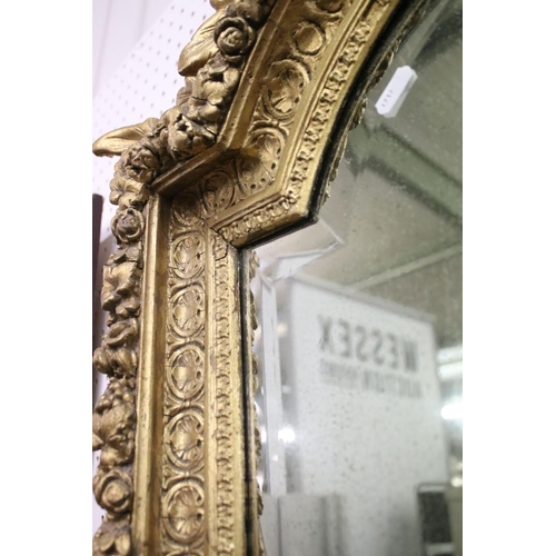 462 - 19th century Italian style shaped Wall Mirror held with a Floral Carved Giltwood and Gesso Frame, 10... 