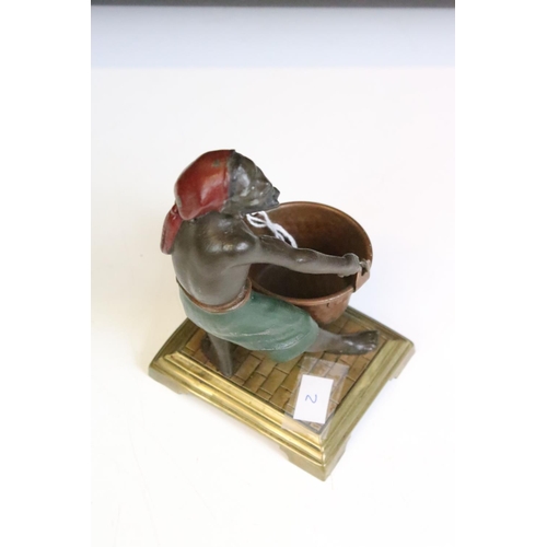 124 - Spelter polychrome figure of a man with bucket, on brass base. Approx 14.5cm high