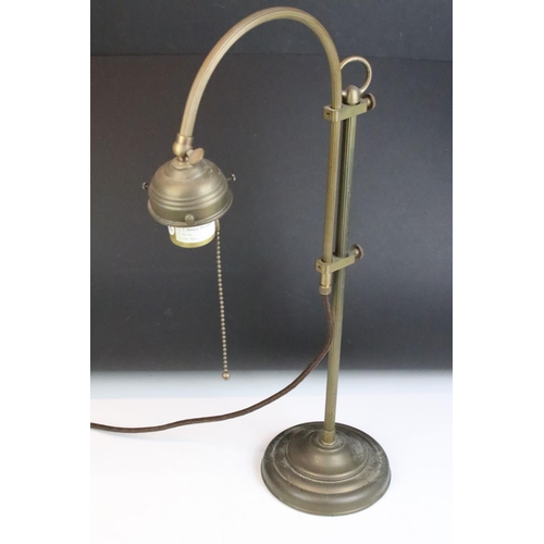 139 - Edwardian brass adjustable desk lamp, with reeded support, raised on a circular base. Measures 55.5c... 