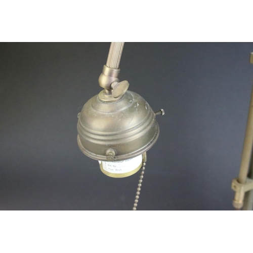 139 - Edwardian brass adjustable desk lamp, with reeded support, raised on a circular base. Measures 55.5c... 