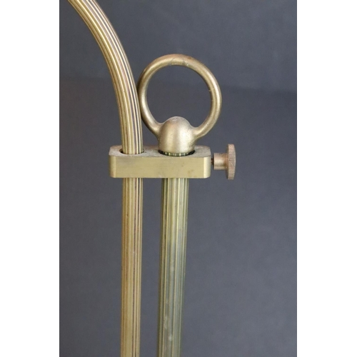 139 - Edwardian brass adjustable desk lamp, with reeded support, raised on a circular base. Measures 55.5c... 