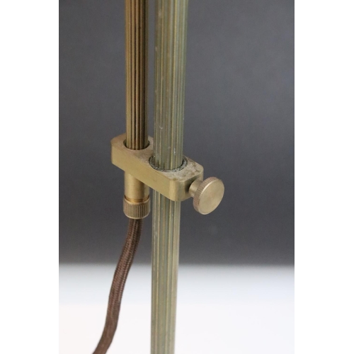 139 - Edwardian brass adjustable desk lamp, with reeded support, raised on a circular base. Measures 55.5c... 