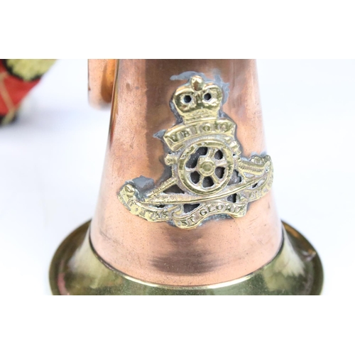 140 - Copper & brass bugle with applied Royal Artillery badge, braided cord tassels. Measures approx. 26cm... 