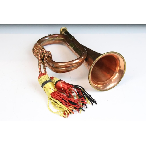 140 - Copper & brass bugle with applied Royal Artillery badge, braided cord tassels. Measures approx. 26cm... 