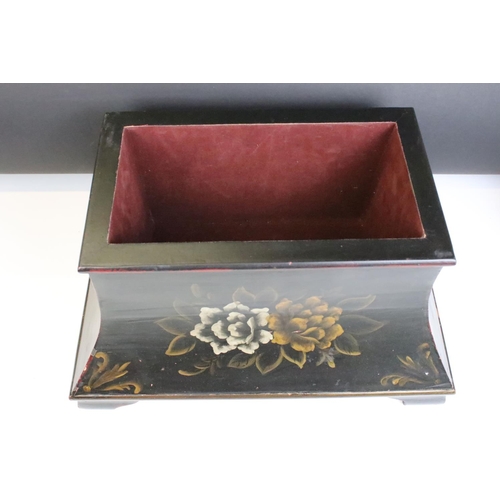 146 - A sarcophagus shaped black wooden box with hand painted decoration and velvet lined interior. Approx... 