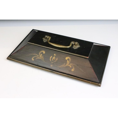 146 - A sarcophagus shaped black wooden box with hand painted decoration and velvet lined interior. Approx... 