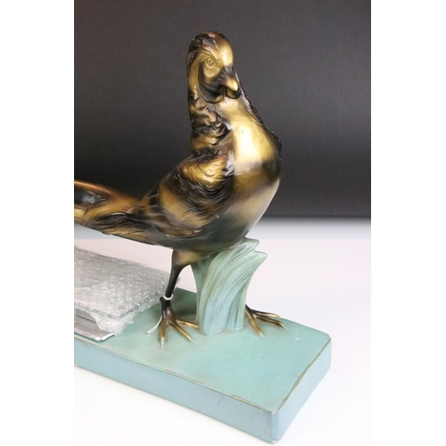 151 - Art Deco style moulded plaster figure of a golden pheasant, with menu / photograph holder metal fitt... 