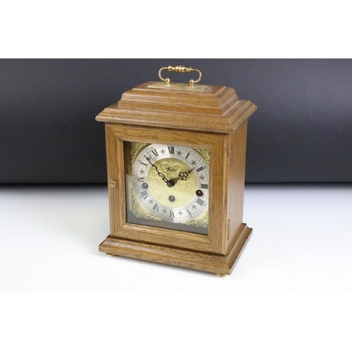 173 - Oak cased Woodford bracket clock, the brass dial with silvered chapter ring, glazed front door, bras... 