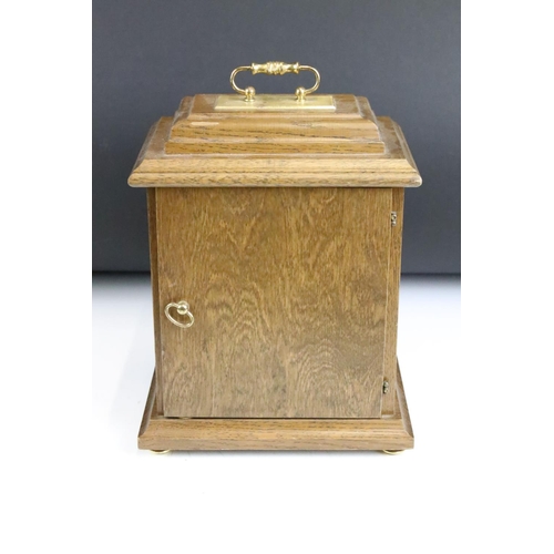 173 - Oak cased Woodford bracket clock, the brass dial with silvered chapter ring, glazed front door, bras... 