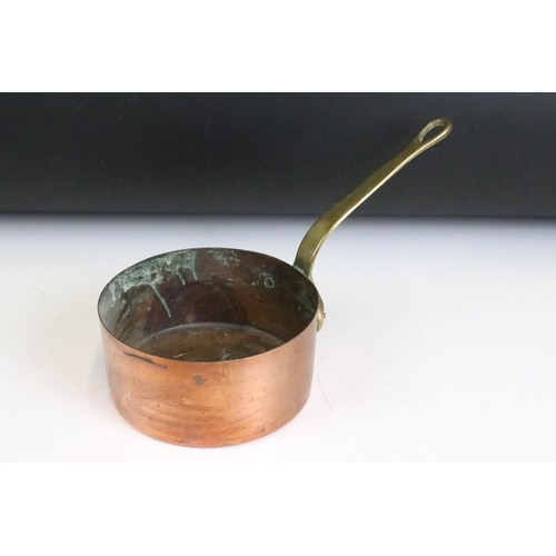 176 - A set of six graduated copper saucepans with brass handles, largest measures 16cm diameter.