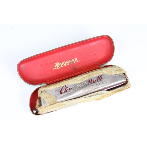 179 - A collection of four vintage Hohner harmonicas / mouth organs to include a Chrometta 14 example.