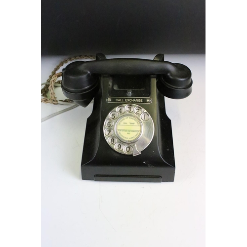 180 - Two early to mid 20th century black home telephones one labeled 'Call Exchange'.