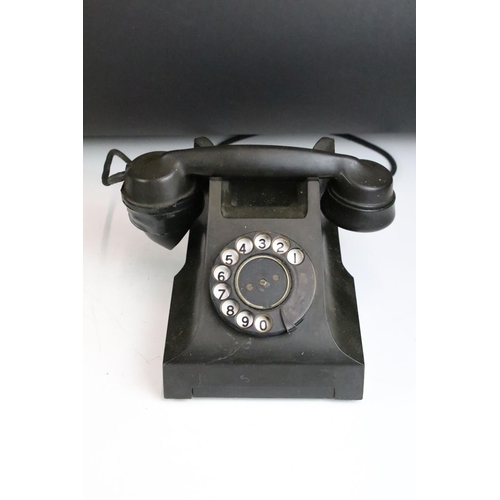 180 - Two early to mid 20th century black home telephones one labeled 'Call Exchange'.