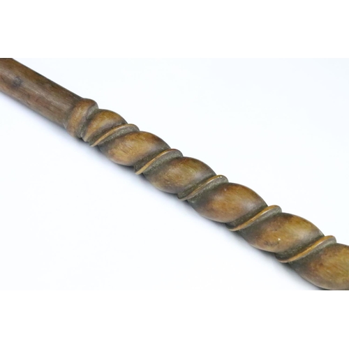 194 - A finely carved wooden riding crop with dog's head finial, measures approx 37cm in length.