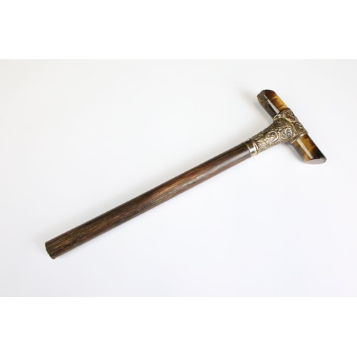 195 - An antique parasol or walking stick handle, tigers eye cross handle with hallmarked 15ct gold mounti... 