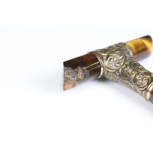 195 - An antique parasol or walking stick handle, tigers eye cross handle with hallmarked 15ct gold mounti... 