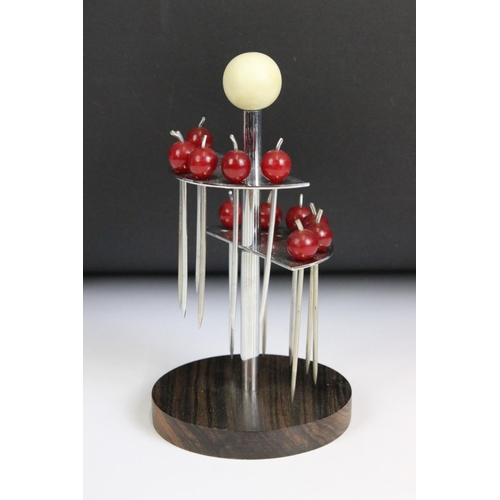 199 - A stylised Art Deco cocktail stick set, sticks with cherry amber finials on nickel plate and wooden ... 