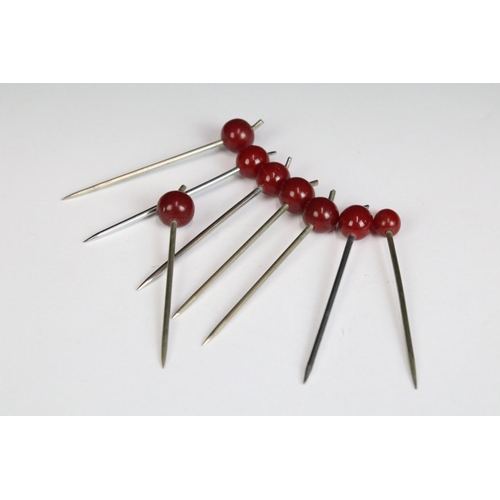 199 - A stylised Art Deco cocktail stick set, sticks with cherry amber finials on nickel plate and wooden ... 