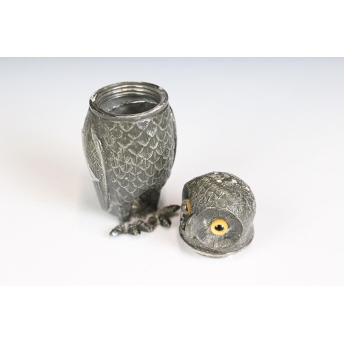 200 - An antique pewter pepper shaker in the form of an owl with glass eyes, stands approx 7.5cm in height... 