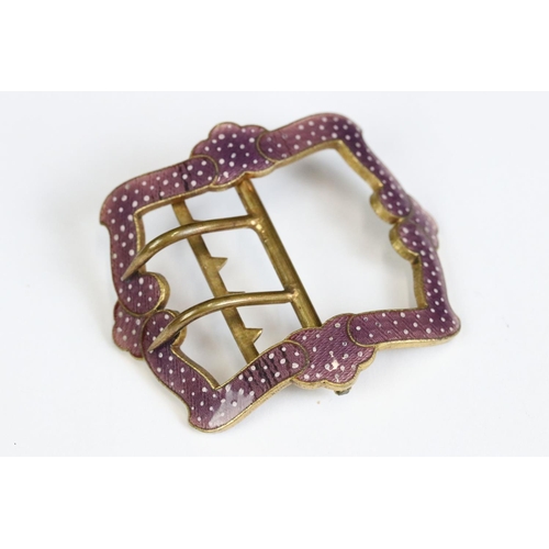 213 - An antique brass shoe buckle with ornate purple enamel decoration.