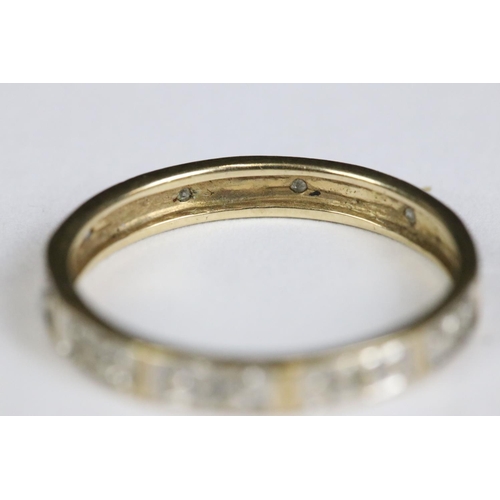 214 - A ladies 9ct gold and sapphire dress ring together with a yellow metal eternity ring.