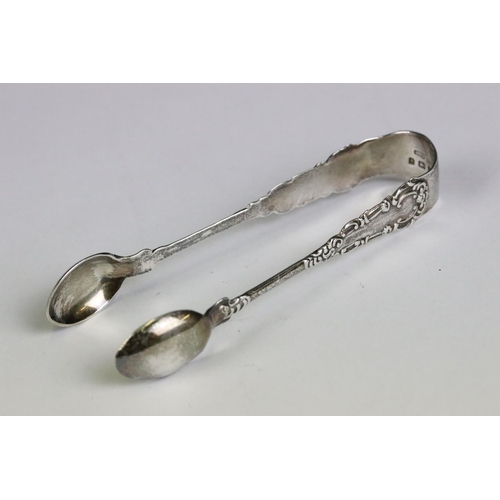 220 - A small collection of mixed sterling silver to include a money clip, sugar tongs and two forks one h... 