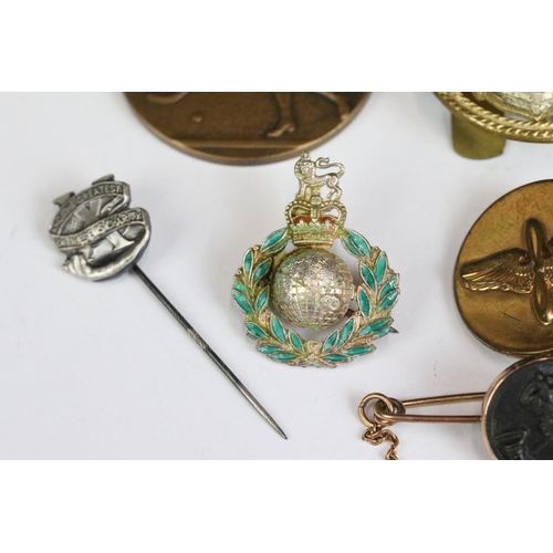 226 - A small collection of mainly military related badges and buttons.