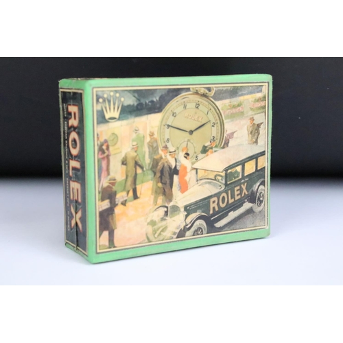 239 - A Rolex pocket watch box with advertising graphics to all sides.