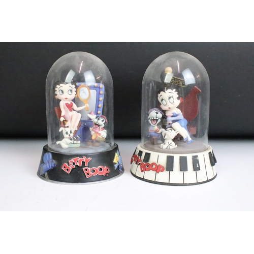 261 - A collection of eight Betty Boop hand painted resin sculptures within glass domes.