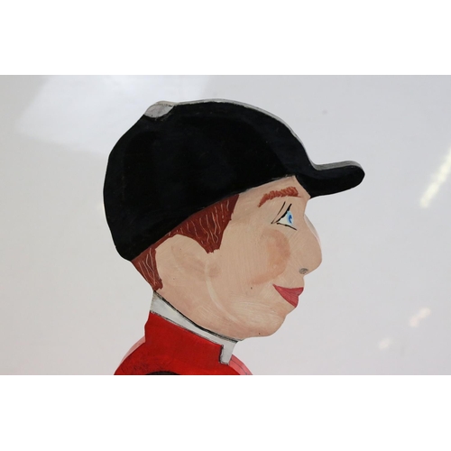 350 - A wooden dumb waiter in the form of a Jockey, stands approx 85cm in height.