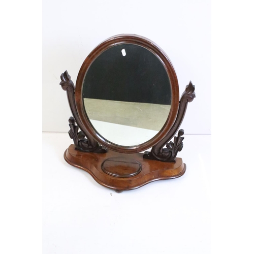 467 - Victorian Mahogany Oval Swing Dressing Mirror, held on carved supports and a shaped base with glove ... 