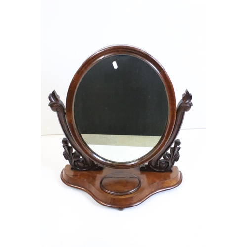 467 - Victorian Mahogany Oval Swing Dressing Mirror, held on carved supports and a shaped base with glove ... 