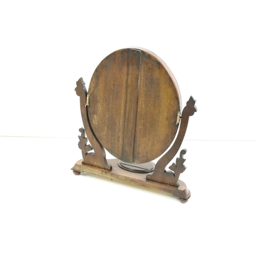 467 - Victorian Mahogany Oval Swing Dressing Mirror, held on carved supports and a shaped base with glove ... 