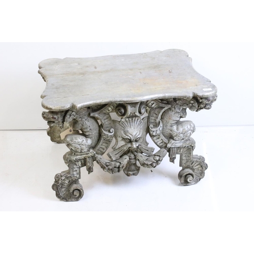 526 - Italianate Silver Painted Low Table with shaped top, raised on a base carved with lion masks, 76cm l... 