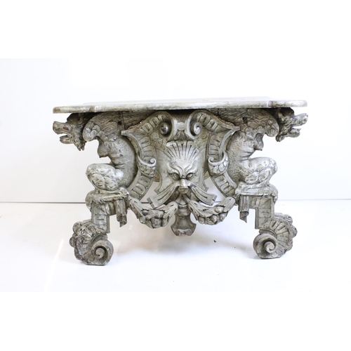 526 - Italianate Silver Painted Low Table with shaped top, raised on a base carved with lion masks, 76cm l... 